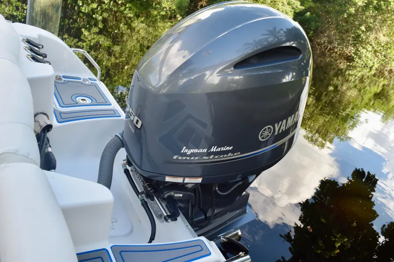 Slide: The Image of 2018 Sea Hunt Ultra 211 boat with Yamaha outboard motor on calm water. - 15