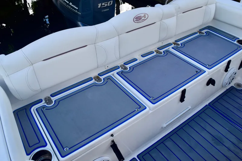 Slide: The Image of 2018 Sea Hunt Ultra 211 boat interior with cushioned seating and storage compartments. - 17
