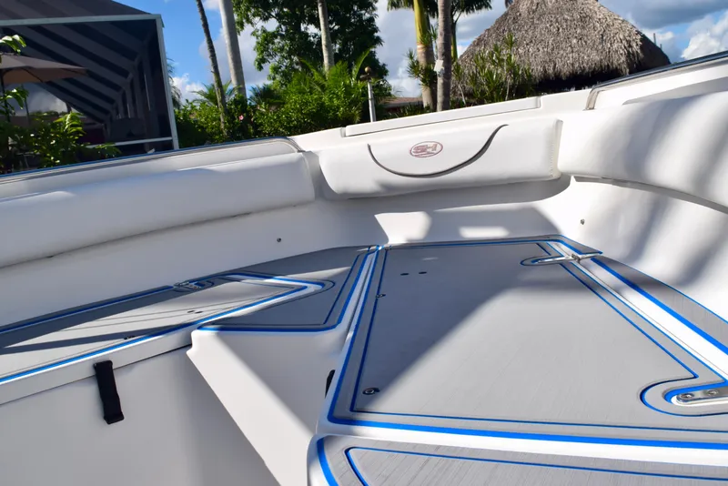 Slide: The Image of 2018 Sea Hunt Ultra 211 boat interior with cushioned seating and sleek design. - 22