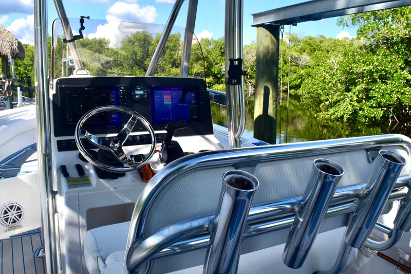 Slide: The Image of 2018 Sea Hunt Ultra 211 boat dashboard with steering wheel and navigation screens. - 27