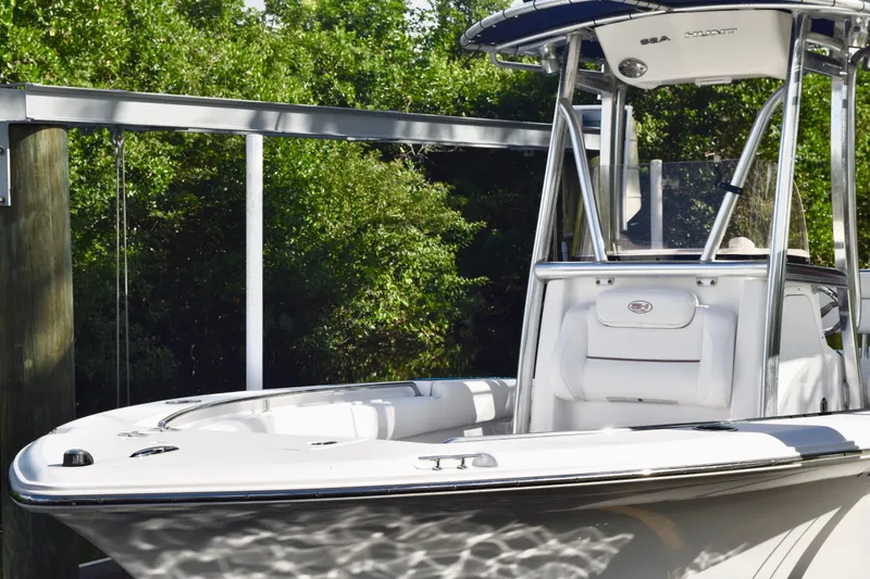 Slide: The Image of 2018 Sea Hunt Ultra 211 boat docked, featuring sleek design and modern amenities. - 3