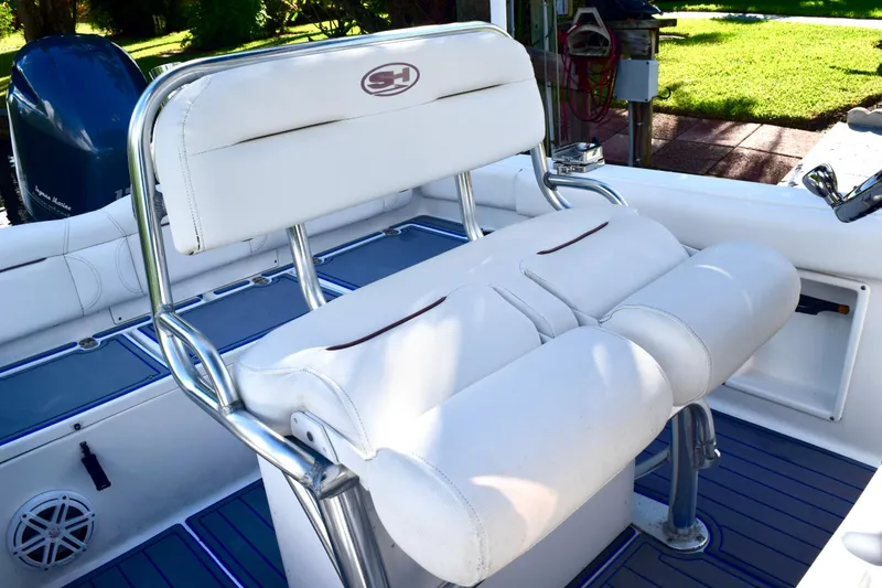 Slide: The Image of 2018 Sea Hunt Ultra 211 boat interior with white cushioned seating and stainless steel frame. - 30