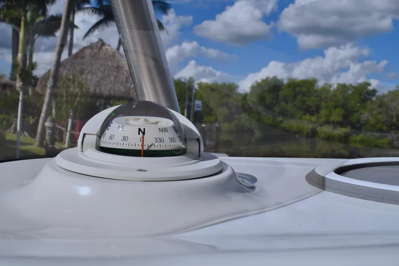 Slide: The Image of Compass on 2018 Sea Hunt Ultra 211 boat, with tropical background and blue sky. - 33