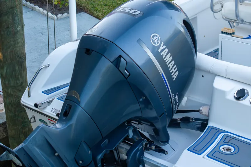 Slide: The Image of Yamaha outboard motor on 2018 Sea Hunt Ultra 211 boat, docked near greenery. - 48