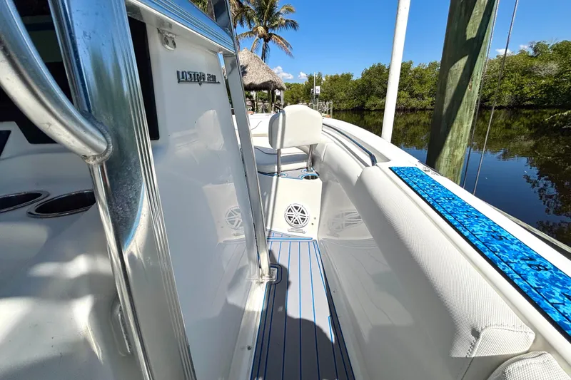 Slide: The Image of 2018 Sea Hunt Ultra 211 boat interior with sleek design and blue accents. - 51