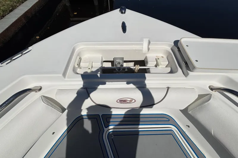Slide: The Image of 2018 Sea Hunt Ultra 211 boat deck with anchor storage and seating. - 59