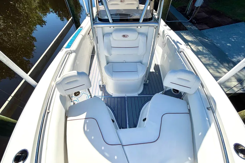Slide: The Image of 2018 Sea Hunt Ultra 211 boat interior with white seating and sleek design. - 65