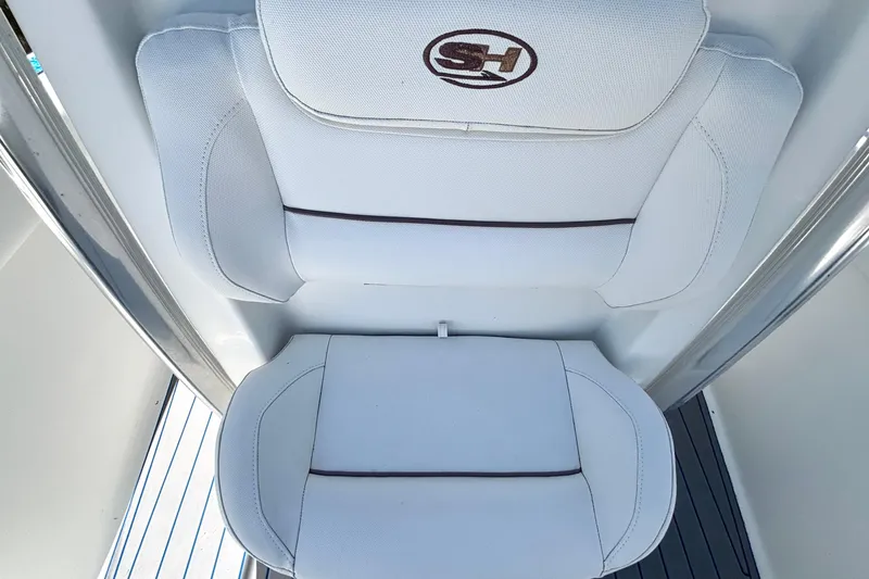 Slide: The Image of White cushioned seats on 2018 Sea Hunt Ultra 211 boat, featuring SH logo. - 69