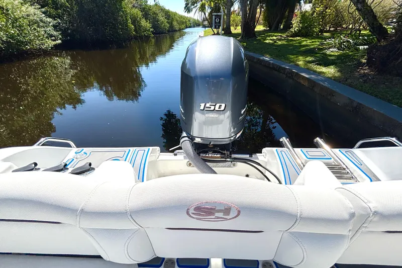 Slide: The Image of 2018 Sea Hunt Ultra 211 boat with Yamaha 150 engine on a scenic waterway. - 86
