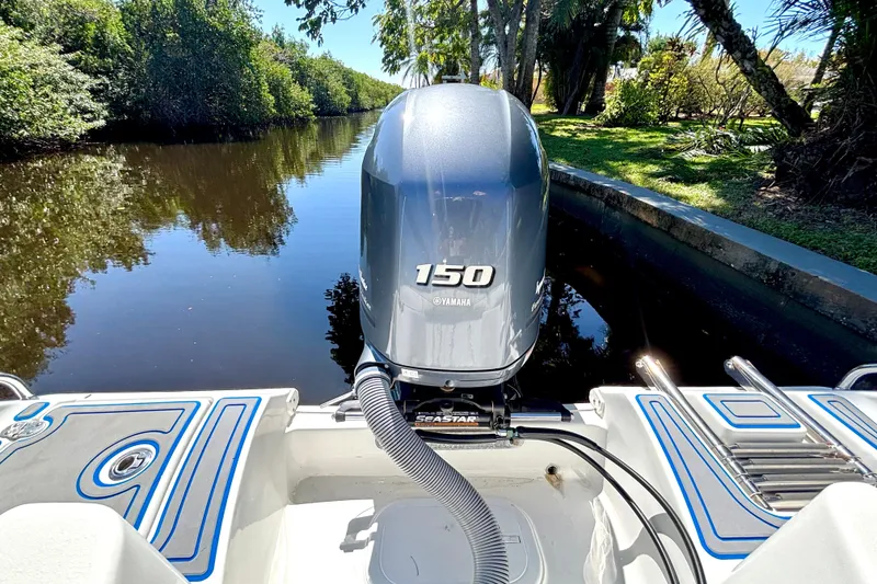 Slide: The Image of 2018 Sea Hunt Ultra 211 boat with Yamaha 150 engine on a scenic waterway. - 88