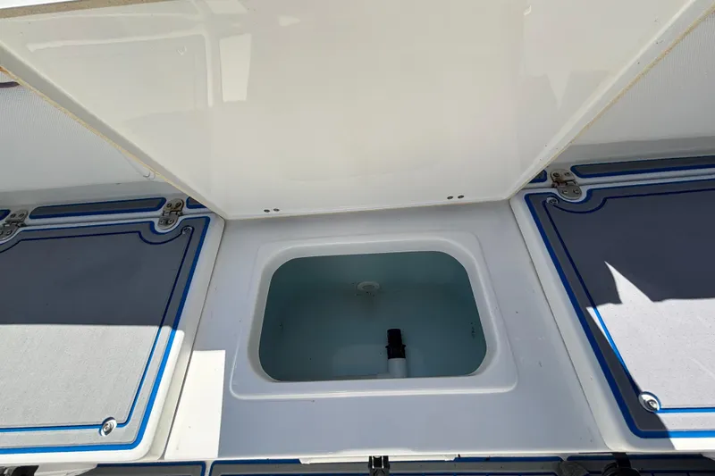 Slide: The Image of Open storage compartment on a 2018 Sea Hunt Ultra 211 boat. - 92