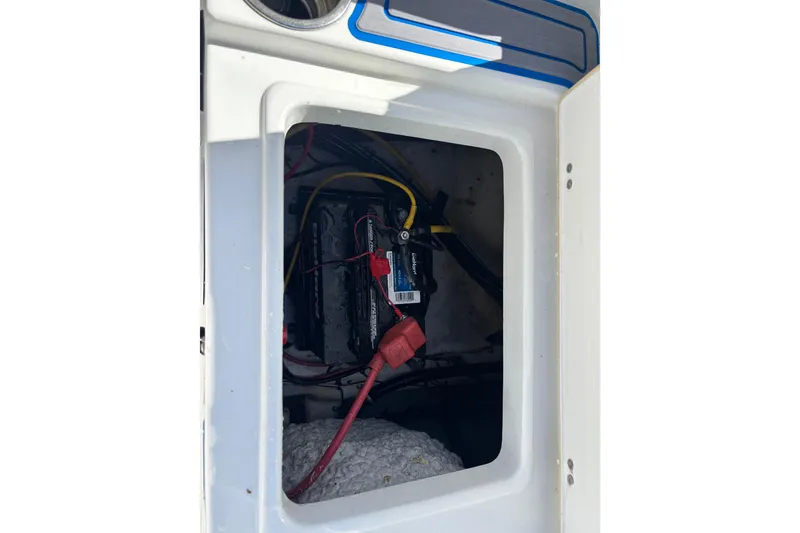 Slide: The Image of Battery compartment of 2018 Sea Hunt Ultra 211 boat with visible wiring. - 94