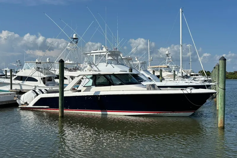 Slide: The Image of 2024 Tiara Yachts 48 LS cruising on a calm, sunny day with blue skies. - 0