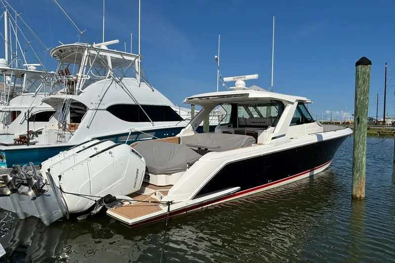 Slide: The Image of 2024 Tiara Yachts 48 LS cruising on a calm, sunny lake. - 1