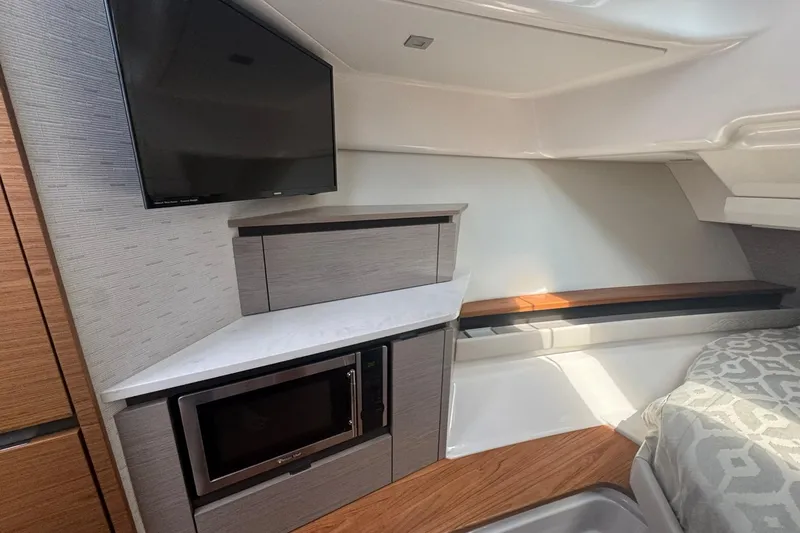 Slide: The Image of 2024 Tiara Yachts 48 LS luxury boat cruising on calm blue waters. - 11