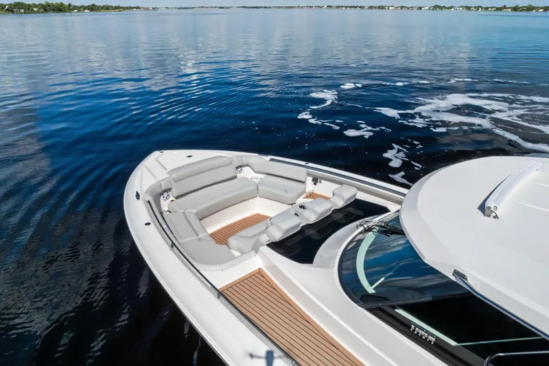 Slide: The Image of 2024 Tiara Yachts 48 LS luxury yacht on calm water, featuring spacious seating. - 20