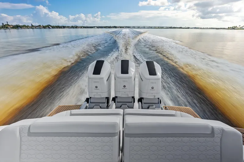 Slide: The Image of 2024 Tiara Yachts 48 LS cruising with powerful outboard engines, leaving a dynamic wake. - 23