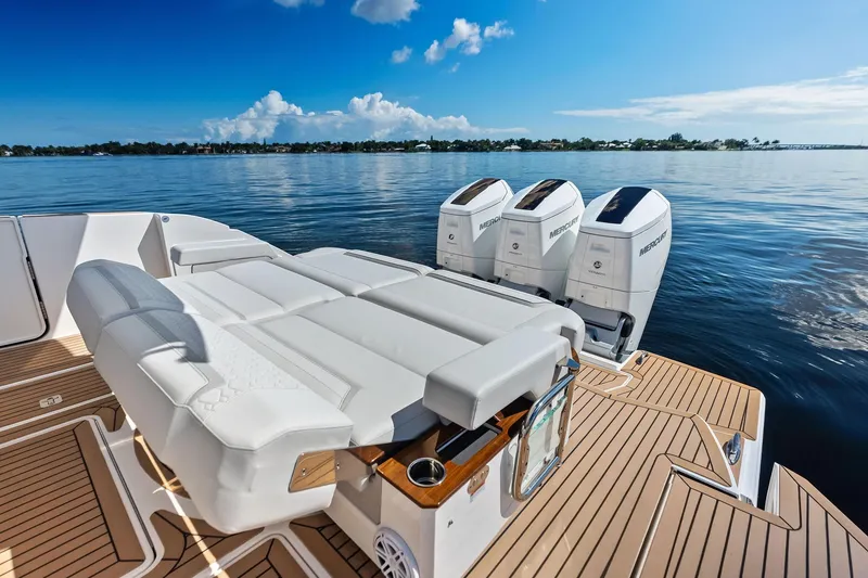 Slide: The Image of 2024 Tiara Yachts 48 LS with triple Mercury engines on calm water. - 25