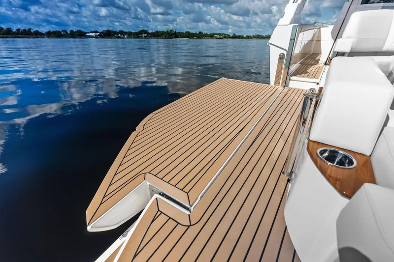 Slide: The Image of 2024 Tiara Yachts 48 LS with sleek deck design on calm waters. - 28
