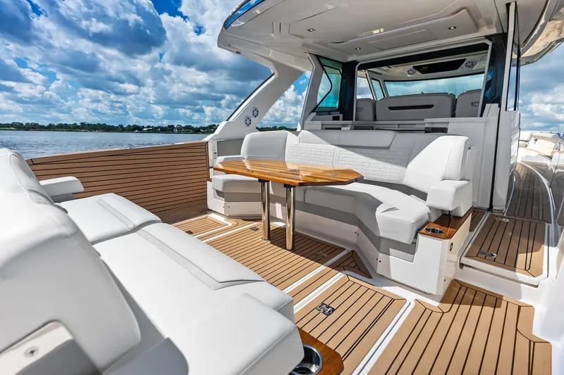 Slide: The Image of 2024 Tiara Yachts 48 LS luxury yacht interior with elegant seating and wooden accents. - 33