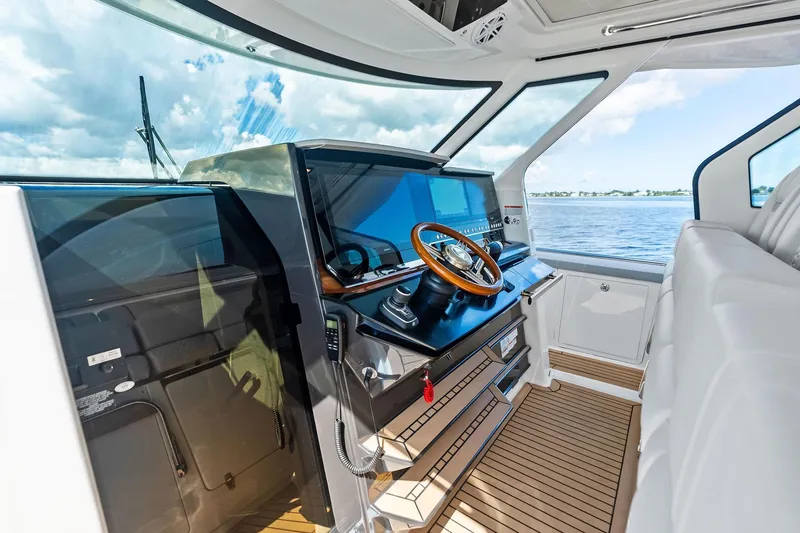 Slide: The Image of 2024 Tiara Yachts 48 LS helm with modern controls and panoramic water view. - 35