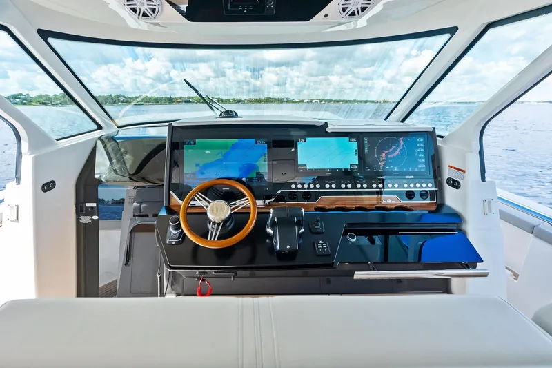 Slide: The Image of 2024 Tiara Yachts 48 LS helm with advanced navigation displays and luxurious interior. - 36