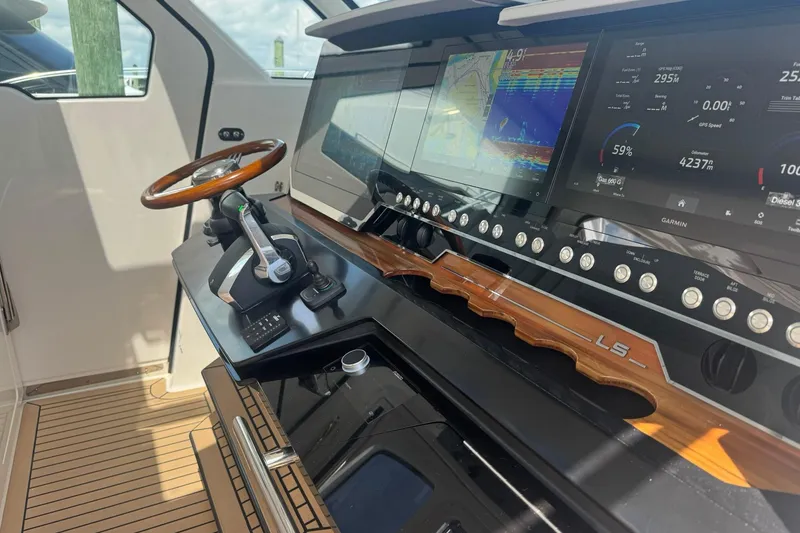 Slide: The Image of 2024 Tiara Yachts 48 LS cruising on a sunny day, creating a dynamic water trail. - 4