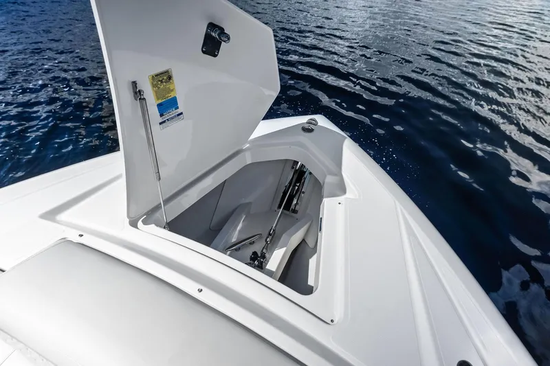 Slide: The Image of 2024 Tiara Yachts 48 LS open storage compartment on calm water. - 41