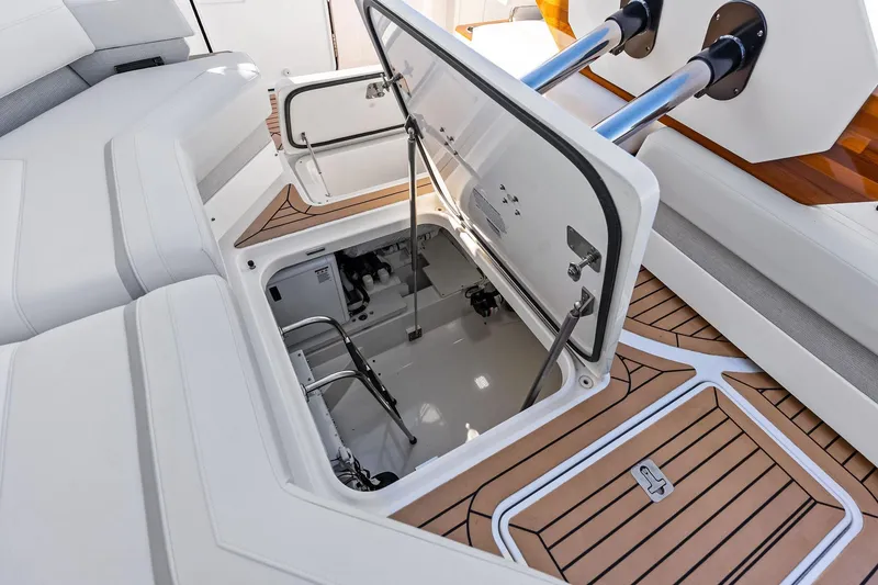 Slide: The Image of 2024 Tiara Yachts 48 LS engine compartment with open hatch, showcasing interior details. - 42