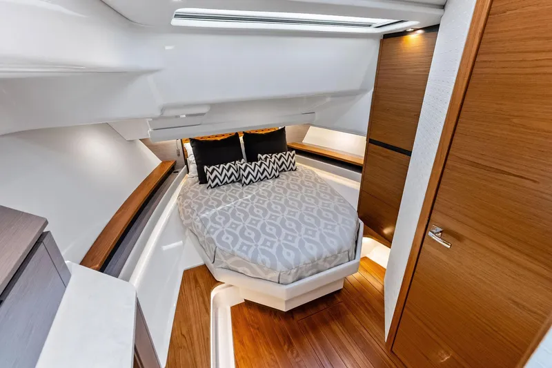 Slide: The Image of Luxurious cabin interior of 2024 Tiara Yachts 48 LS with modern design and cozy bedding. - 44