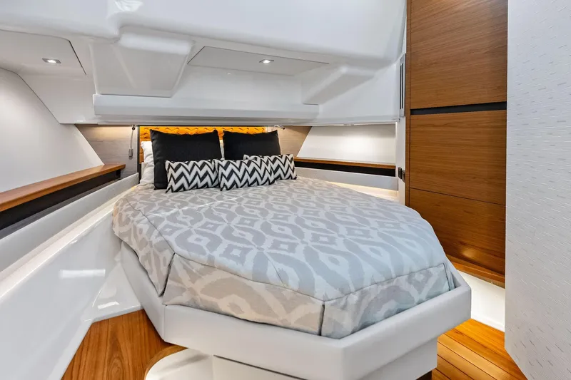 Slide: The Image of Luxurious cabin interior of 2024 Tiara Yachts 48 LS with elegant bedding and wood accents. - 45