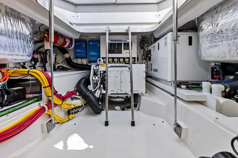Slide: The Image of Engine room of 2024 Tiara Yachts 48 LS, featuring wiring and equipment. - 52