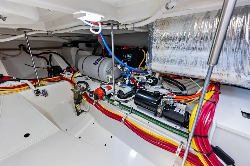 Slide: The Image of Engine room of 2024 Tiara Yachts 48 LS, showcasing wiring and mechanical components. - 54