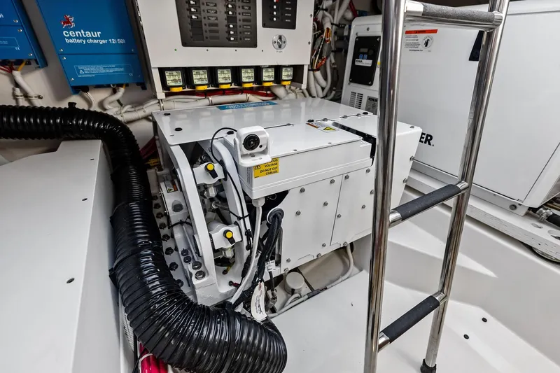 Slide: The Image of Engine room of 2024 Tiara Yachts 48 LS, featuring battery charger and equipment. - 55