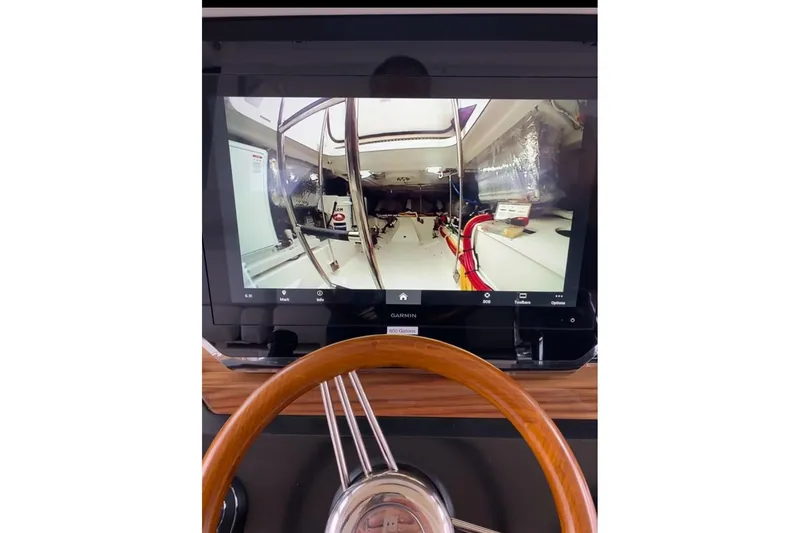 Slide: The Image of 2024 Tiara Yachts 48 LS cruising on a calm lake under a cloudy sky. - 7