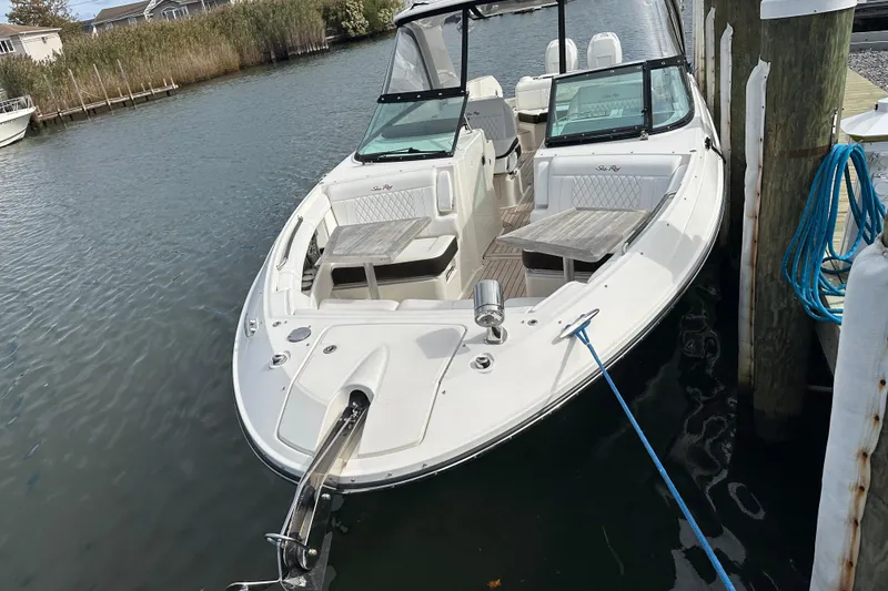 The Image of 2019 Sea Ray SLX 350 Outboard boat docked, featuring spacious seating and sleek design. - 0