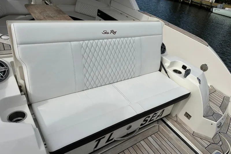 Slide: The Image of 2019 Sea Ray SLX 350 Outboard boat with white cushioned seating and elegant design. - 12