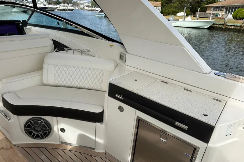 Slide: The Image of Luxurious interior of 2019 Sea Ray SLX 350 Outboard with seating and kitchenette. - 21