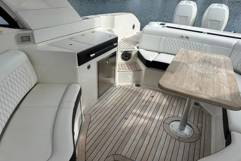 Slide: The Image of Luxurious 2019 Sea Ray SLX 350 Outboard interior with elegant seating and wooden table. - 24