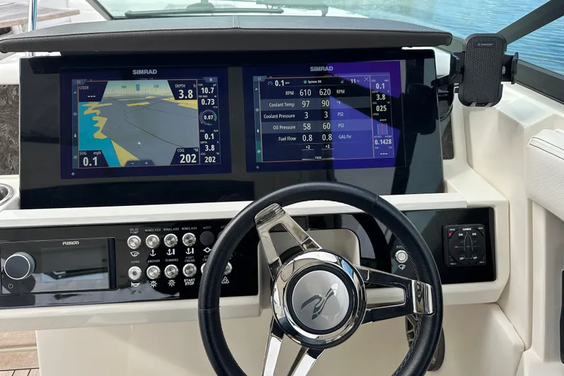 Slide: The Image of 2019 Sea Ray SLX 350 Outboard dashboard with dual Simrad displays and steering wheel. - 27