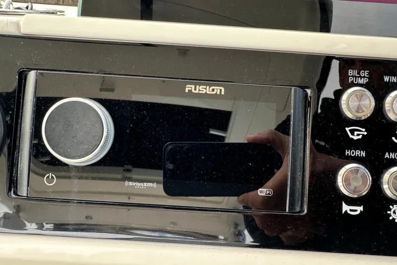 Slide: The Image of Fusion audio system on 2019 Sea Ray SLX 350 Outboard boat dashboard. - 36
