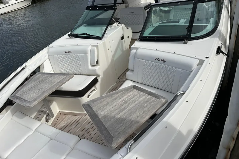 Slide: The Image of 2019 Sea Ray SLX 350 Outboard boat with elegant seating and wooden tables. - 5