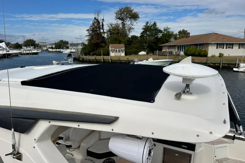 Slide: The Image of 2019 Sea Ray SLX 350 Outboard boat docked, featuring sleek design and modern amenities. - 6