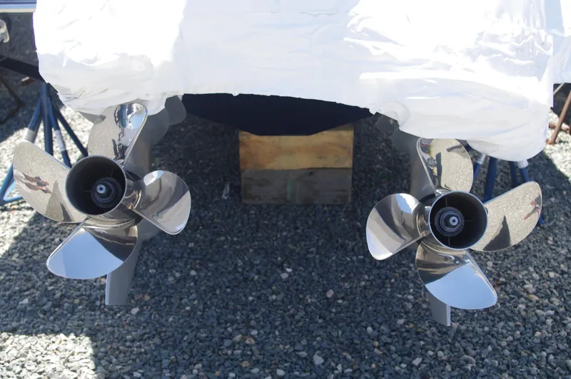 Slide: The Image of Valhalla Boatworks V-33 2025 model twin propellers on gravel. - 37