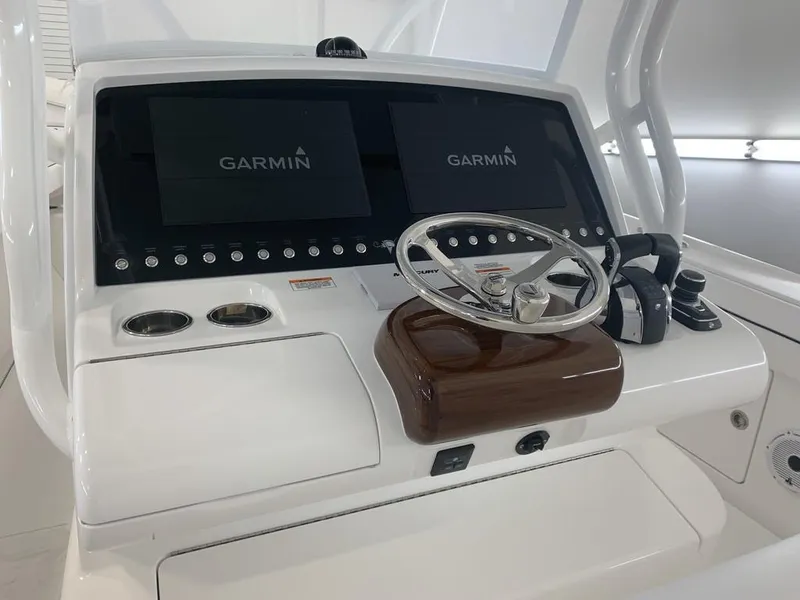 Slide: The Image of 2025 Valhalla Boatworks V-33 helm with dual Garmin displays and polished steering wheel. - 7