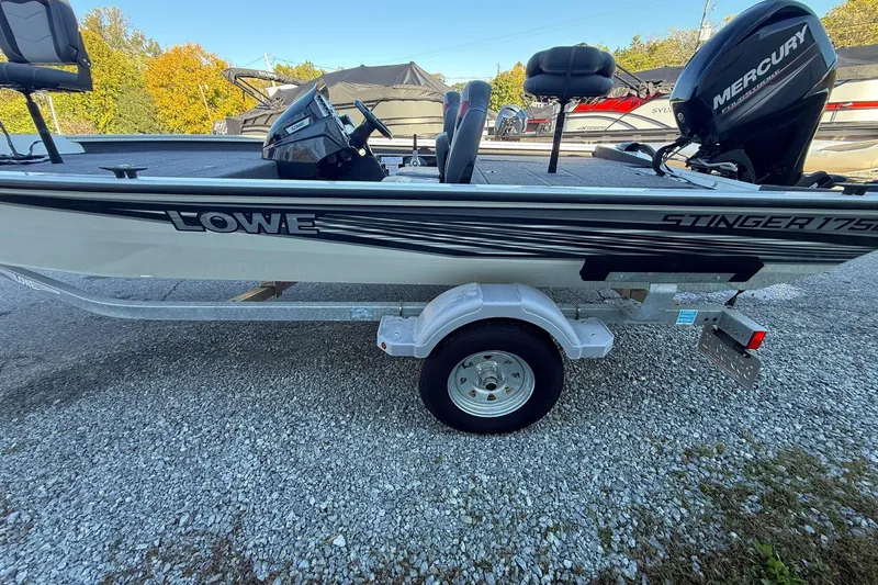 Slide: The Image of 2018 Lowe Stinger 175C boat on trailer with Mercury outboard motor. - 1