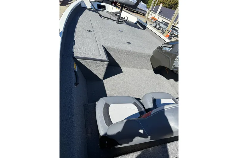 Slide: The Image of 2018 Lowe Stinger 175C boat interior with seating and carpeted deck. - 12