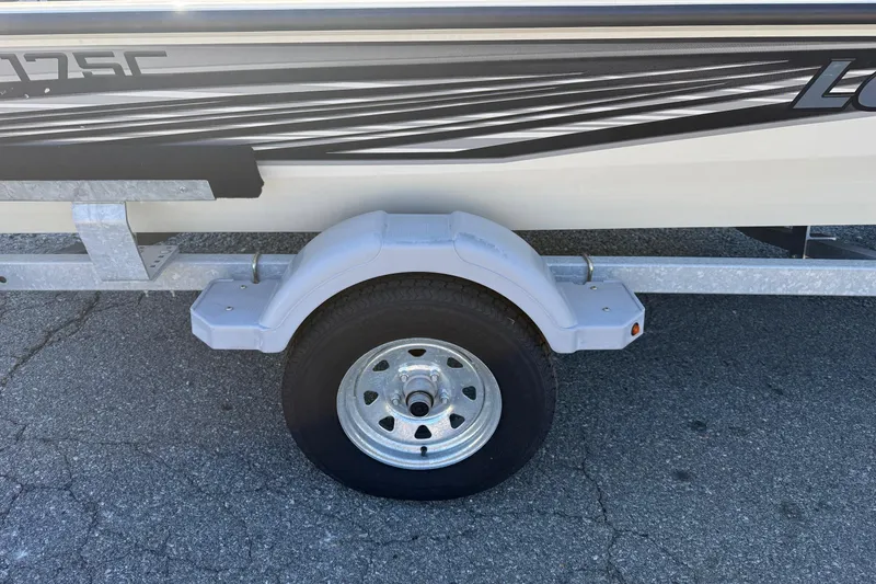 Slide: The Image of 2018 Lowe Stinger 175C boat trailer with wheel and fender on asphalt. - 13