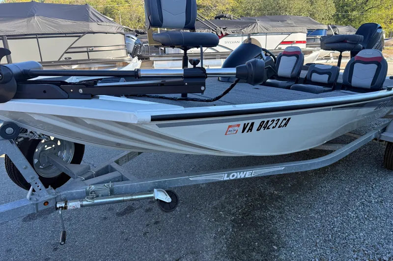 Slide: The Image of 2018 Lowe Stinger 175C fishing boat on trailer, featuring comfortable seating and sleek design. - 17