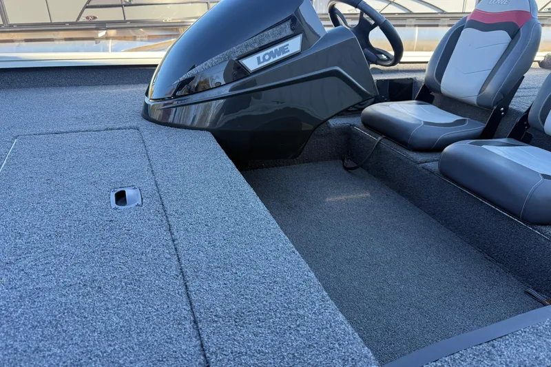 Slide: The Image of 2018 Lowe Stinger 175C boat interior with steering console and seating. - 19